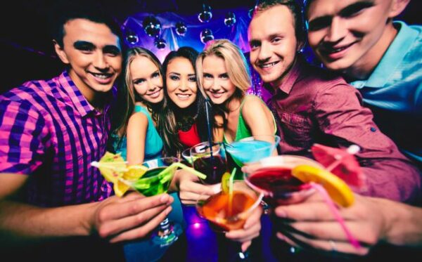Group of happy friends with cocktails at party